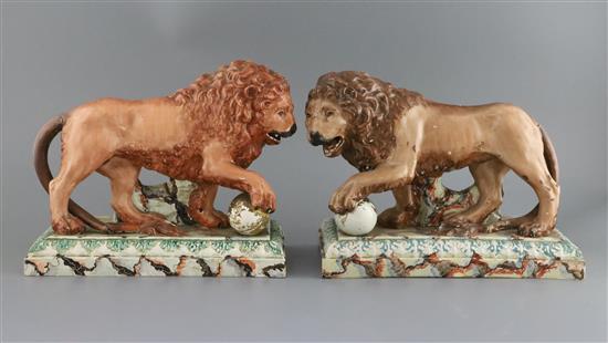 A near pair of large Ralph Wood type pearlware figures of Medici lions, c.1800-10, L. 33.5cm